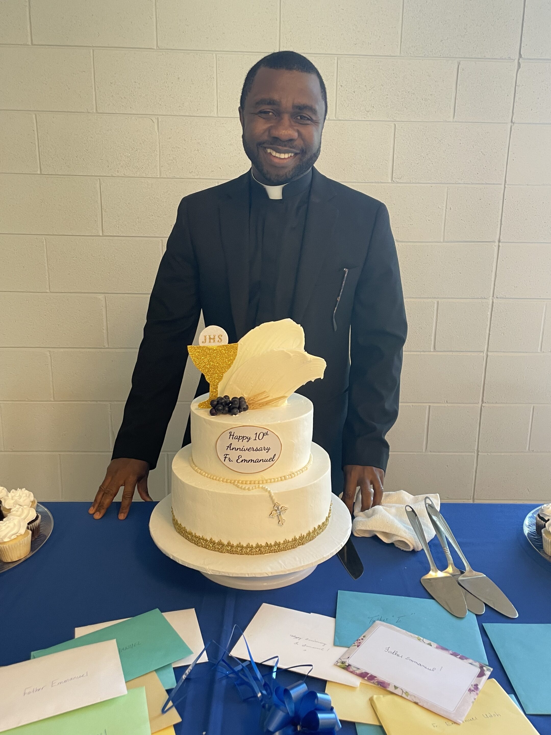 Fr E and cake Fr. Stephen Van Lal Than